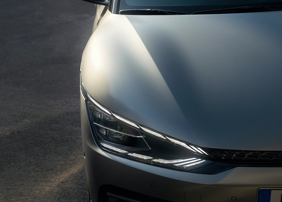 The front headlight and bonnet of a Kia car.